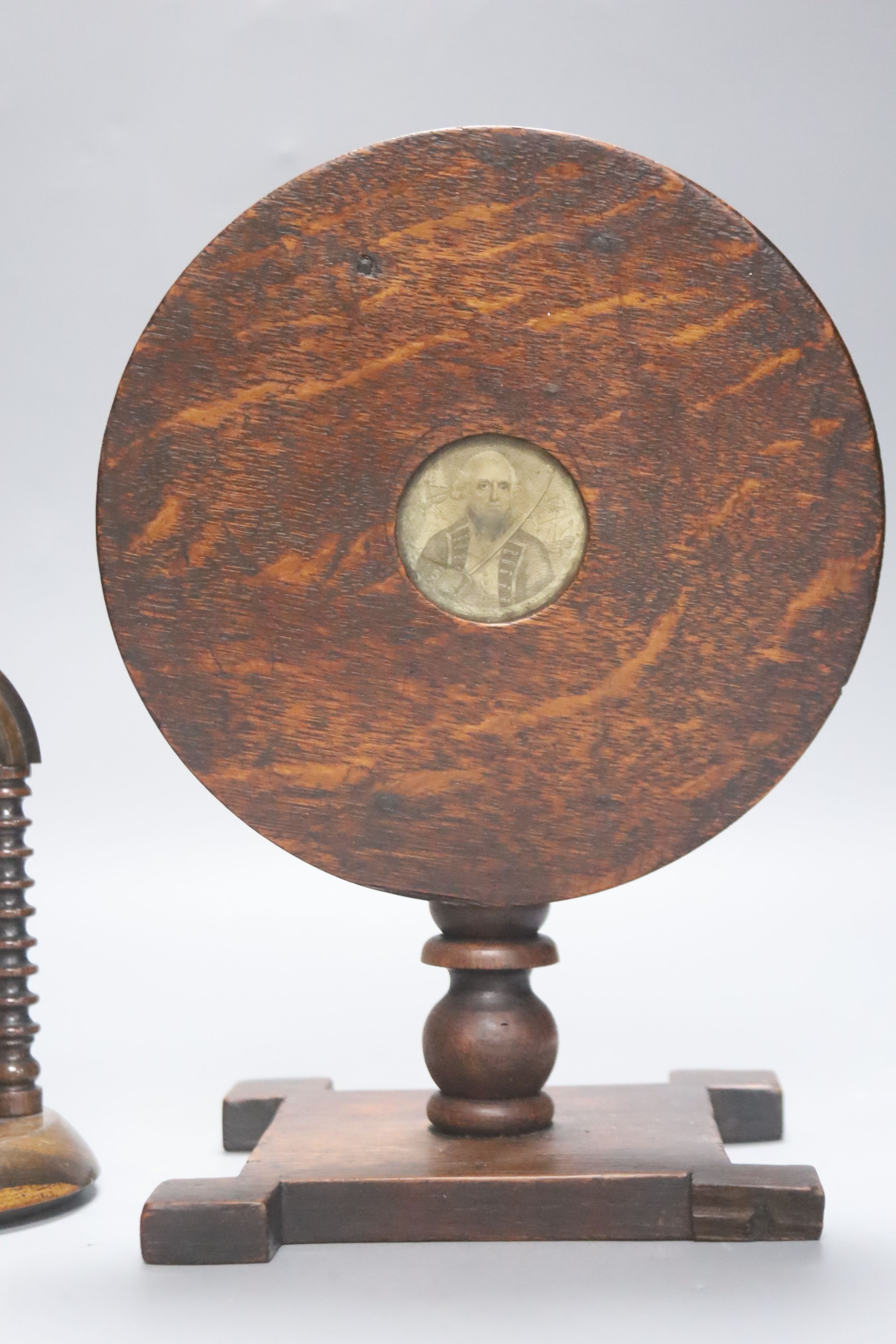 A 19th century oak miniature tilt top table with naval portrait, 23.5cm high tilted up, and a lignum vitae watchstand